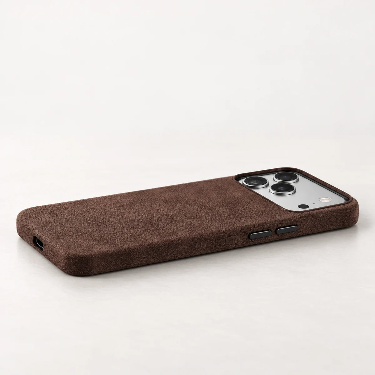 Low side view of an espresso brown fabric phone case with black controls and a black camera rim.