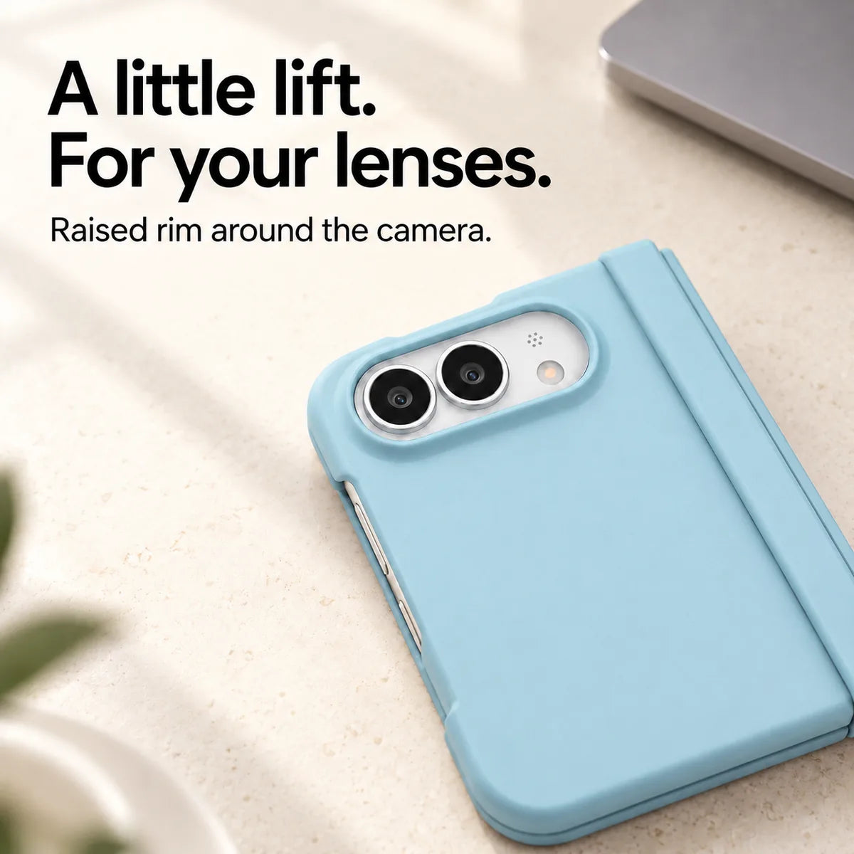 Close-up of the raised Sky Blue camera rim on a matte iPhone Ultra case resting on a light desk. #color_Glacier Blue