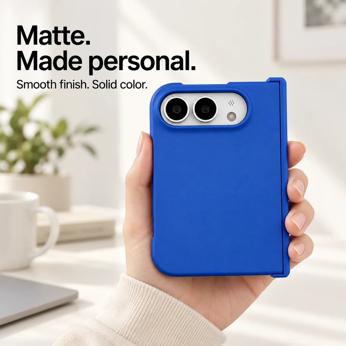 Blue matte iPhone Ultra case held in one hand, with a smooth solid-color rear shell and silver camera area. #color_Cobalt Blue