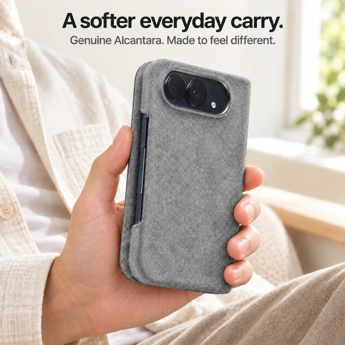 Mist Gray Alcantara folio case for iPhone Duo, held in a hand to show the soft fabric finish #color_Mist Gray