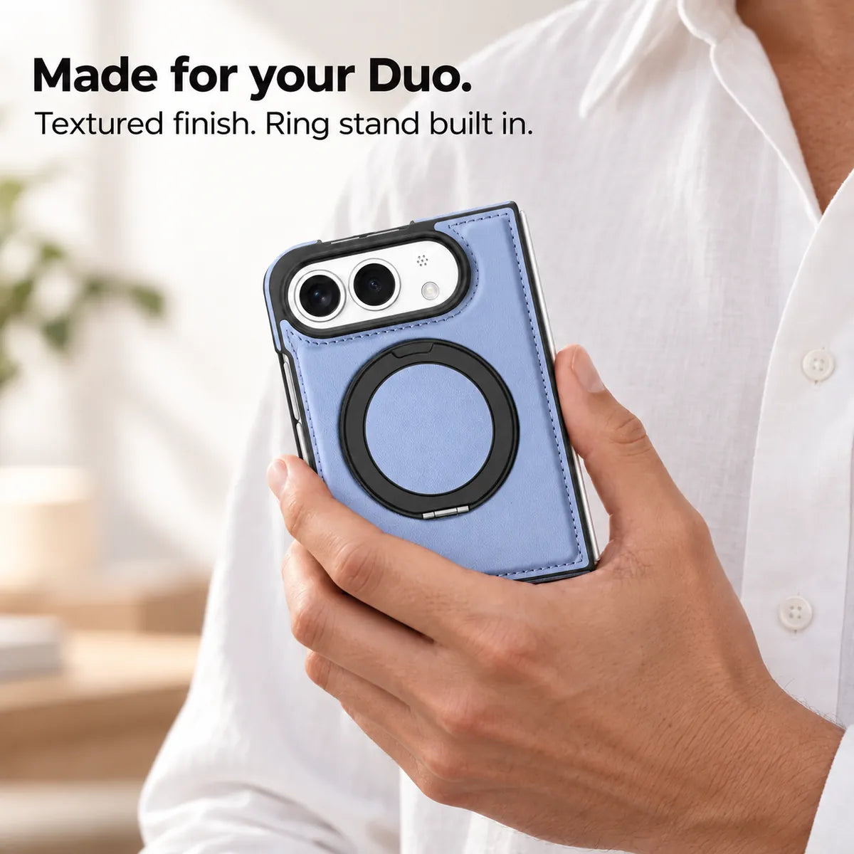 Hand holding a textured synthetic leather folding phone case with the ring stand folded flat. #color_Glacier