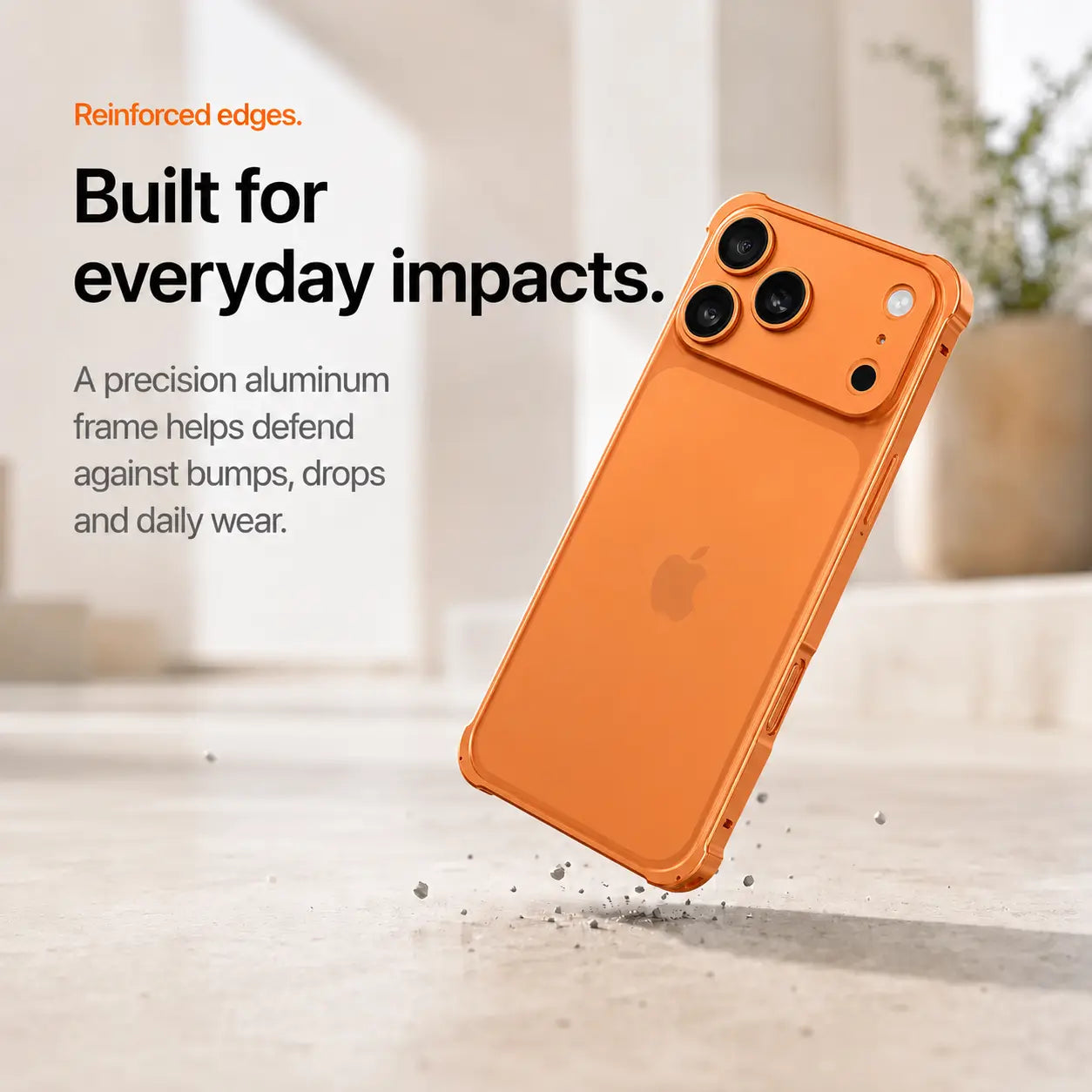 Orange aluminum bumper phone case shown during a corner drop demonstration #color_Cosmic Orange