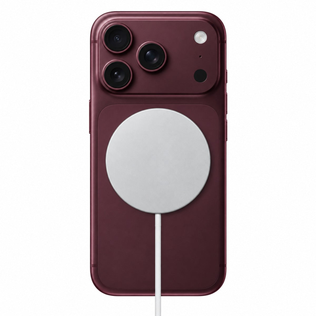 Qi2 25W magnetic wireless charger attached to a Burgundy iPhone.