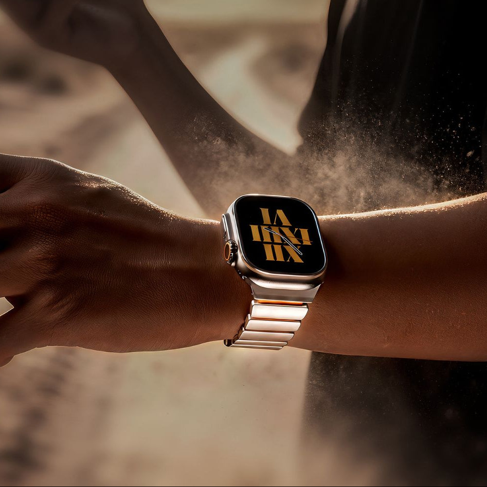 Smartwatch with a metallic band on a wrist, with a blurred background