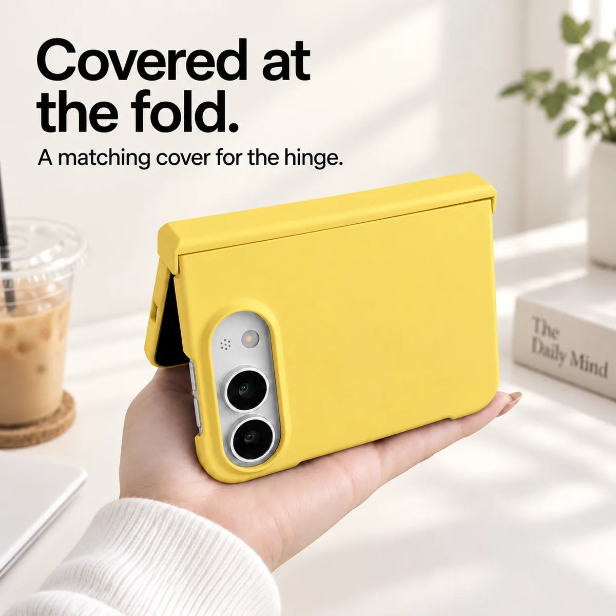 Yellow iPhone Ultra case held partly folded, showing the matching cover along the hinge. #color_Solstice Yellow