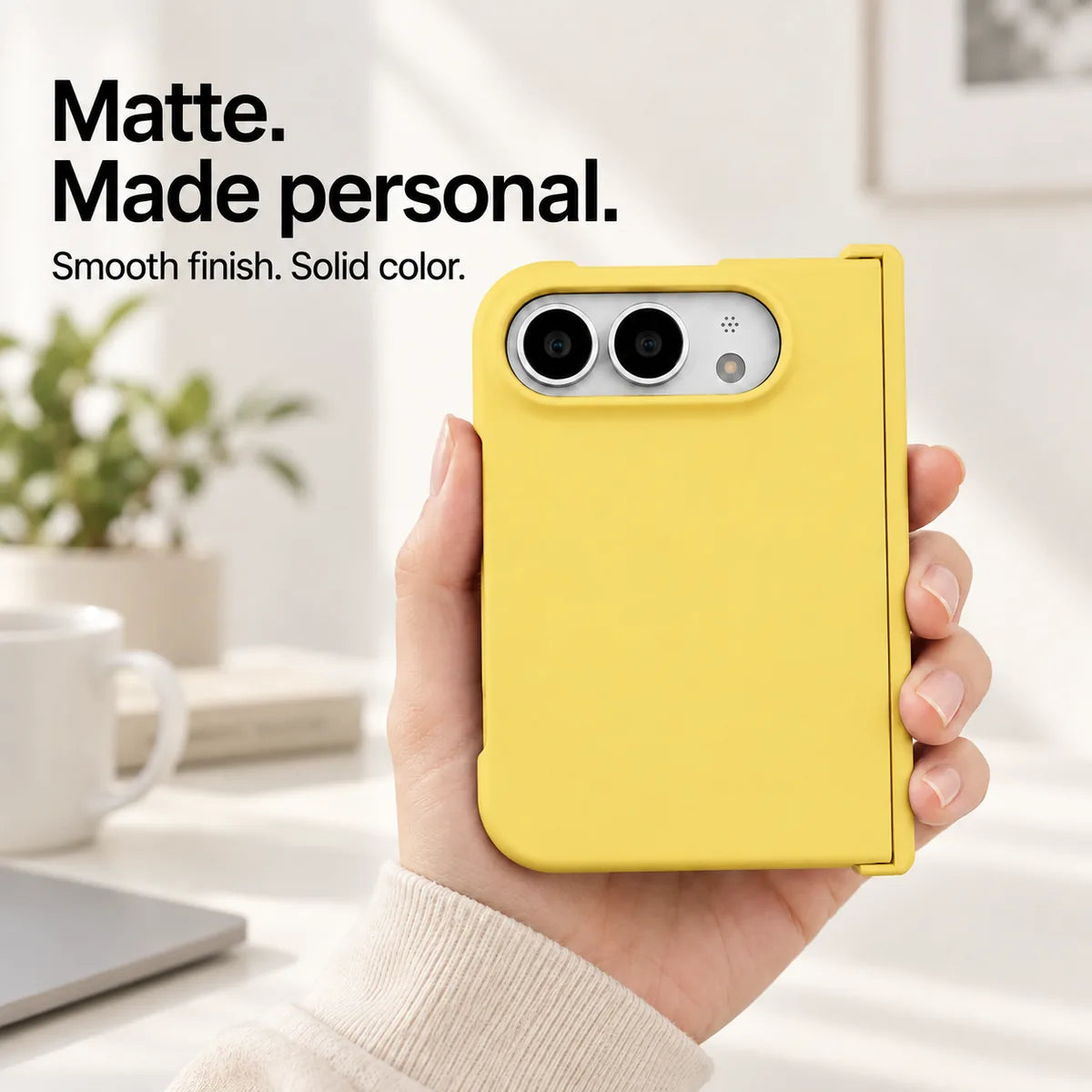 Yellow matte iPhone Ultra case held in one hand, with a smooth solid-color rear shell and silver camera area. #color_Solstice Yellow